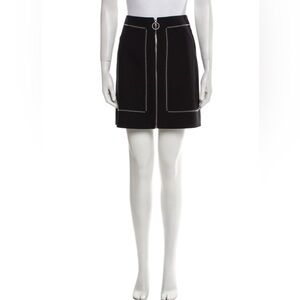Maje women’s Jimenez black skirt with silver studs & front zipper. Size 38.